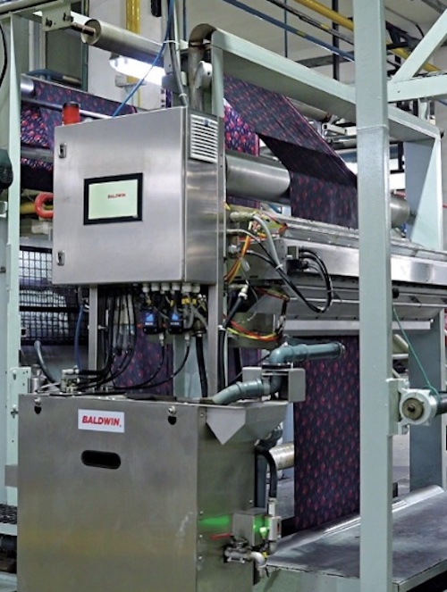 BW Converting s Baldwin Texcoat G4 is shown in operation as Zaman Textile Mills © 2026  BARRY-WEHMILLER