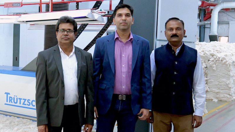 From left to right: Gautam Kumar Dhang (CEO Fabric Business Gimatex), Vineet Mohota (Director Gimatex) and Manish Deolankar (General Manager Gimatex) in front of Trützschler’s Bale Opener © 2024 Trützschler From left to right: Gautam Kumar Dhang (CEO Fabric Business Gimatex), Vineet Mohota (Director Gimatex) and Manish Deolankar (General Manager Gimatex) in front of Trützschler’s Bale Opener © 2024 Trützschler