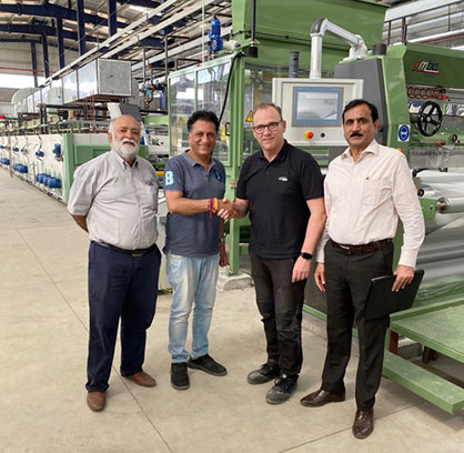 Pictured at the new installation (left to right) are Jayessh S Nanavati of Sainite Exports, JR Mehta of Candour Techtex, Barry Goodwin, and Sanjay Jain, Amba's coating technologist in India. © 2023 Amba