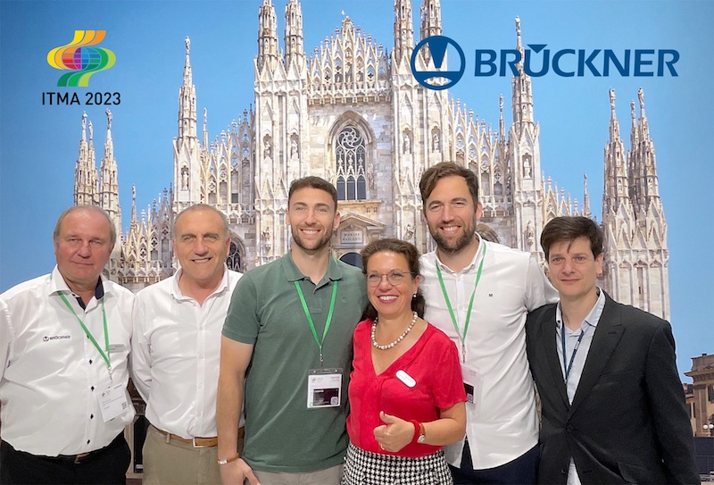 Souvenir photo at the Brückner stand at the ITMA: (from left to right) Dirk Städter (Brückner), Enrique Campos (owner), Vicente Campos (owner), Regina Brückner (owner), Fernando Campos (owner), Jorge Ferrer-Dalmau (Brückner Agent) (c) 2024 Brückner Souvenir photo at the Brückner stand at the ITMA: (from left to right) Dirk Städter (Brückner), Enrique Campos (owner), Vicente Campos (owner), Regina Brückner (owner), Fernando Campos (owner), Jorge Ferrer-Dalmau (Brückner Agent) (c) 2024 Brückner