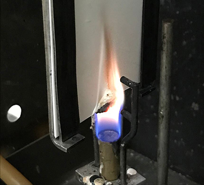 PAL...VersaCHAR™ in a vertical 60 second vertical burn test at 1,950°C, with black char-bodies forming at the bottom of the nonwoven wallcovering substrate.