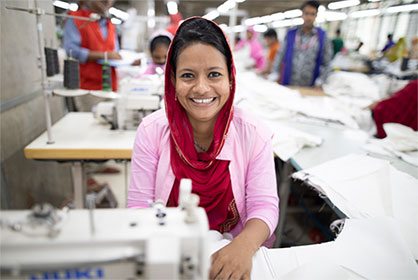 Photo: CARE. Lipiya (20) is Senior Sewing Operator at a ready-made garment factory in Gazipur, Bangladesh. Photo: CARE. Lipiya (20) is Senior Sewing Operator at a ready-made garment factory in Gazipur, Bangladesh.