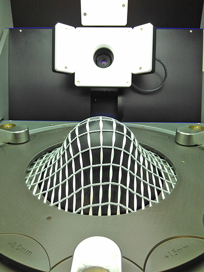 DRAPETEST with CurveTex-textile made of alkali-resistant glass rovings and elastic knitting threads, source: Textechno Herbert Stein GmbH & Co. KG Textile Mess- und Prüftechnik DRAPETEST with CurveTex-textile made of alkali-resistant glass rovings and elastic knitting threads, source: Textechno Herbert Stein GmbH & Co. KG Textile Mess- und Prüftechnik
