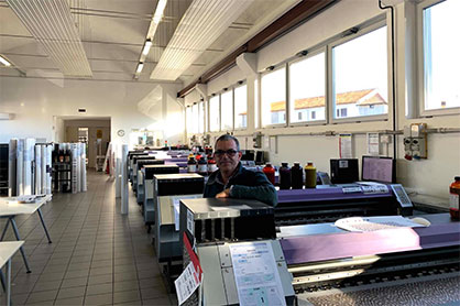 Filippo Taccani, founder and owner at Digitak, in the company’s production department, surrounded by an arsenal of Mimaki’s printing solutions. (c) 2020 Mimaki Filippo Taccani, founder and owner at Digitak, in the company’s production department, surrounded by an arsenal of Mimaki’s printing solutions. (c) 2020 Mimaki
