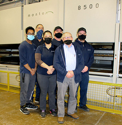 The Albarrie team at the new machine in the company’s plant in Barrie, Ontario. © 2022 Monforts
